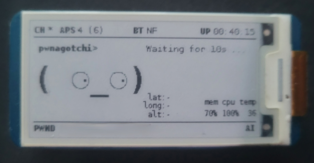 Pwnagotchi e-ink display showing channel hopping across 4 access points, AI mode enabled, 70% memory usage, 100% CPU, and 40 minutes of uptime